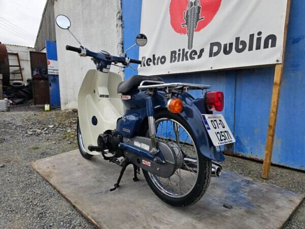 Rear left view of 2007 Honda Super Cub C50 Fuel Injected