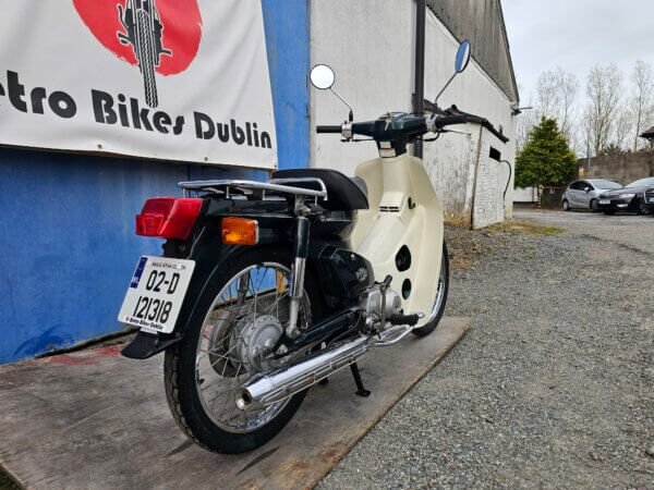 Honda Super Cub C50 from a rear three-quarter angle, showing both side and back details.
